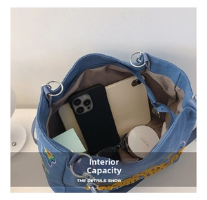 Detailed interior of blue canvas tote bag showing large capacity for tablet and daily items