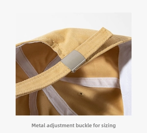 Detailed close-up of the adjustable silver metal buckle on a khaki cotton baseball cap