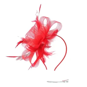Detail of red fascinator headband with mesh flower and feathers for party events