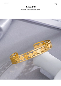 Close-up of 14K gold plated C-shaped cuff bracelet with hammered textured round discs