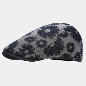 Detail of navy blue and white daisy print on a structured vintage newsboy cap