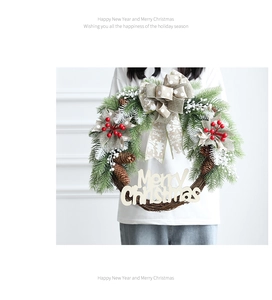 Detailed view of a large Christmas wreath with red berries, pine cones and burlap bow