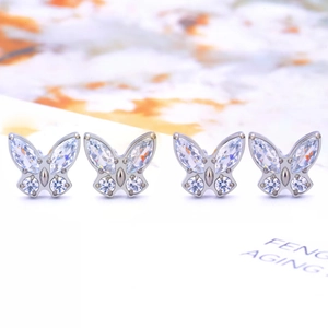 Close-up of titanium butterfly studs featuring marquise and round cut zirconia stones