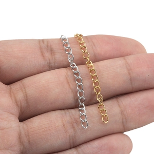 Adjustable stainless steel jewelry extender chains in gold and silver finish shown on finger