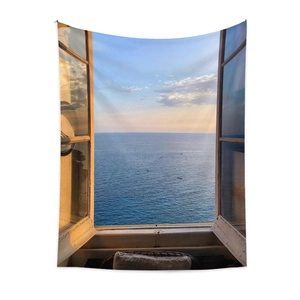 Detail of bohemian tapestry showing a sunset ocean view through an open window