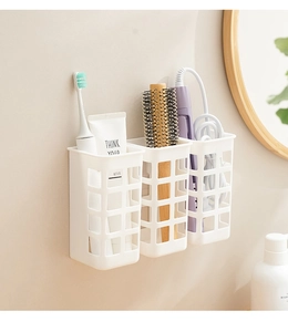 White wall-mounted hair tool organizer with three grid baskets for curling iron storage