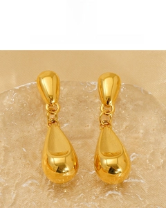 Detail of 18K vacuum plated golden teardrop earrings showing the high gloss polished surface