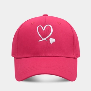 Detailed hot pink cotton baseball cap featuring high-quality white heart embroidery
