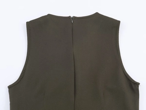 Detailed macro view of the invisible back zipper on a green sleeveless midi dress