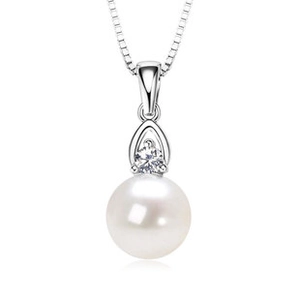 Close-up of a round white freshwater pearl pendant with a sparkling cubic zirconia stone