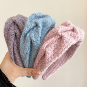 Macro detail of soft knitted texture and pastel color selection for wide headbands