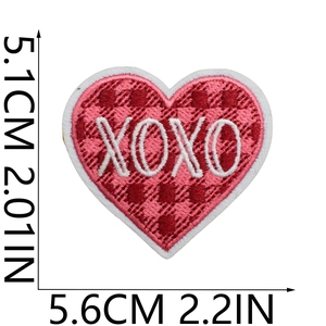 Detailed view of red and pink plaid heart embroidery patch with white XOXO text detail