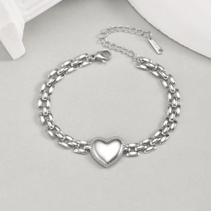 Detail of silver heart charm bracelet in stainless steel with bead edge and lobster clasp
