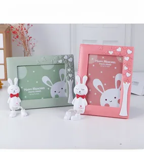 Detail of pink and green cartoon photo frames with 3D bunny and leather-like texture