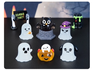 Close-up of Halloween resin miniatures featuring ghosts, owls, and a Zombie Party sign