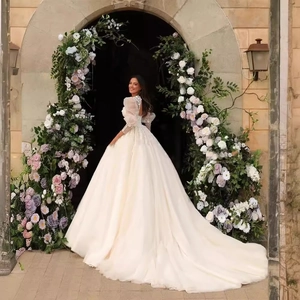 French satin bridal gown with puff sleeves and long lace embroidery train