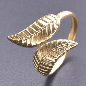 Macro detail of golden double leaf adjustable ring showing delicate vein textures