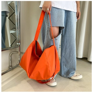 Practical large-capacity orange oxford tote bag shown in use on model for daily fitness
