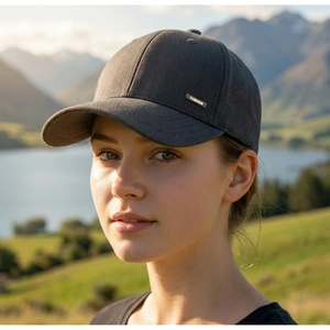 Detail view of the metallic FASHION label on a dark gray men's outdoor baseball cap