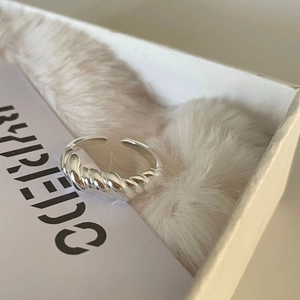 Minimalist 925 sterling silver twisted knot open ring on soft white velvet texture