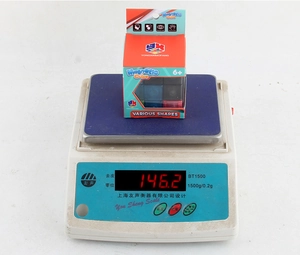 Detailed view of the educational magnetic cube on a digital scale showing weight of 146.2g