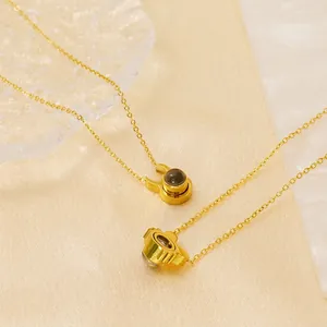 Golden titanium steel projection necklaces featuring bull and sunflower pendant designs