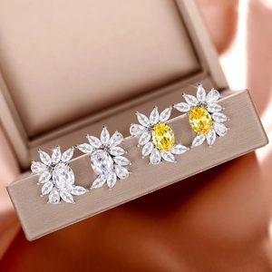 Elegant flower-shaped zircon stud earrings in silver base with yellow and clear crystals