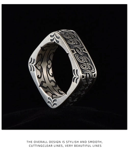 Macro shot of vintage silver square ring with Celtic engravings on black velvet
