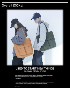 Detailed view of large canvas tote bags in orange and dark green shown on a model
