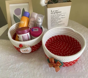 Detail of red and white woven cotton Christmas baskets with Santa and sequin bows