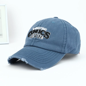 Detail of distressed brim and 3D embroidered lettering on vintage denim baseball cap
