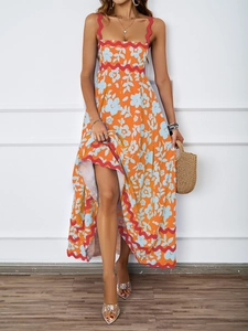 Detail of summer orange sundress featuring light blue floral patterns and pink wavy trim