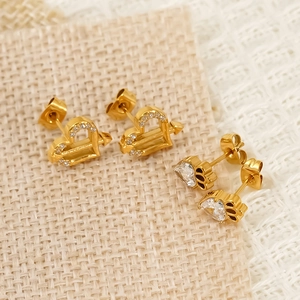 18K gold plated heart and arrow zircon stud earrings for women on linen texture