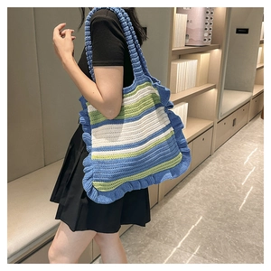Handmade crochet tote bag with blue green white stripes and stylish ruffle trim detail