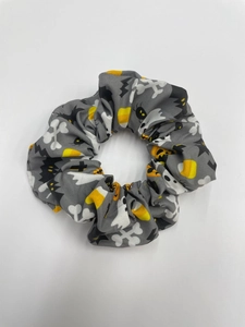 Detail of Halloween fabric scrunchie with ghost, bat, and candy corn printed patterns