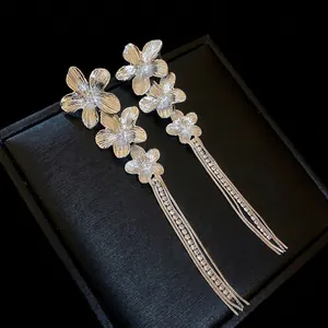 Elegant silver flower earrings with long tassel chains and sparkling rhinestones