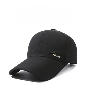Detail shot of golden embroidery logo on a premium black cotton baseball cap side