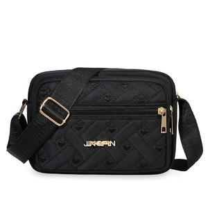 Black quilted heart oxford cloth crossbody bag with gold hardware and adjustable strap