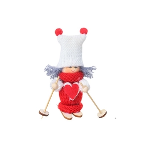 Poupée de Noël tricotée avec bonnet blanc et pull rouge sur des skis en bois décor