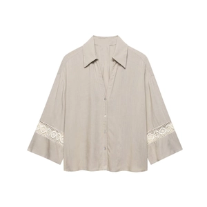 Women's light beige V-neck blouse with intricate lace embroidery on long sleeves