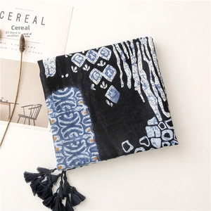 Detail view of ethnic blue and white geometric patterns with decorative fringe tassels