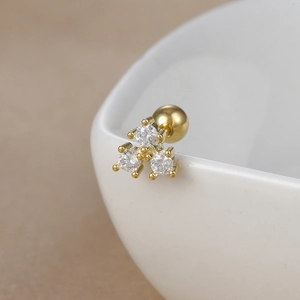 Macro shot of gold-plated stainless steel stud earring featuring three brilliant zircons