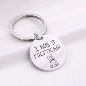 Silver stainless steel round keychain featuring I have a microchip text and dog illustration