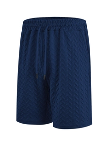 Detail of navy blue jacquard texture and elastic drawstring on men's beach shorts