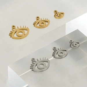 18K gold and silver stainless steel evil eye charms in three sizes on acrylic stands