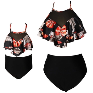 Matching mother-daughter two-piece swimsuit with tropical leaf print and high-waisted bottoms