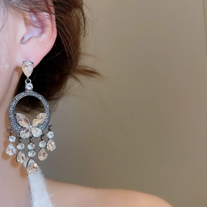 Close-up of butterfly rhinestone tassel earrings with shimmering water-drop crystal dangles