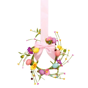 Pink silk bow wreath with colorful Easter eggs and silk flowers for spring home decor