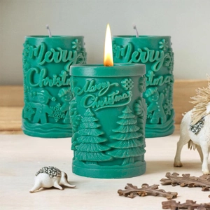 Relief Christmas scented candles in dark green featuring Merry Christmas lettering and tree