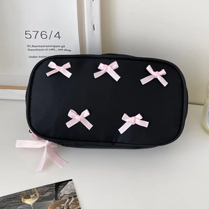 Black rectangular cosmetic bag with six pink bows and decorative ribbon zipper pull